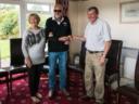 Ian presents grille badge to morning tea hosts Geoff and Pam Barron.